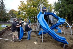 Volunteers assemble playground equipment Saturday afternoon at Gold Bar Elementary School in Gold Bar on October 17, 2020.   (Kevin Clark / The Herald)
