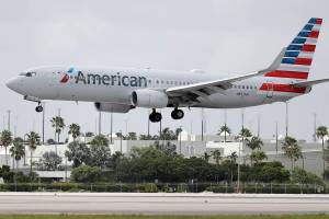 FILE - An American Airlines Boeing 737-823 lands at Miami International Airport, Monday, July 27, 2020, in Miami.American Airlines said Tuesday, Aug. 25 that it will furlough or lay off 19,000 employees in October as it struggles with a sharp downturn in travel because of the pandemic. Flight attendants will bear the heaviest cuts, with 8,100 losing their jobs.  (AP Photo/Wilfredo Lee, File)