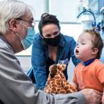 As his mother Whitney Stohr looks on, Malachi Stohr-Hendrickson, a 2-year-old born with spina bifida, is checked by Dr. William Walker. The doctor is a developmental pediatrics specialist with Seattle Childrens Hospital. (Seattle Childrens Hospital photo)