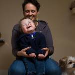 Malachi Stohr, 2, laughs as his mother Whitney sings the Llama Song at home Oct. 21 in Lynnwood. Stohr was born with spina bifida. He has spent much of his life at Seattle Childrens Hospital. (Andy Bronson / The Herald)