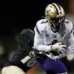 Washington wide receiver Terrell Bynum (right) hauls in a pass as Colorado defensive back Tarik Luckett defends during the second half of a game Nov. 23, 2019, in Boulder, Colo. (AP Photo/David Zalubowski)