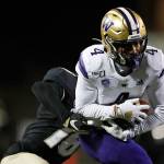 Colorado defensive back Tarik Luckett, back, pulls down Washington wide receiver Terrell Bynum after he caught a pass during the second half of an NCAA college football game Saturday, Nov. 23, 2019, in Boulder, Colo. Colorado won 20-14. (AP Photo/David Zalubowski)