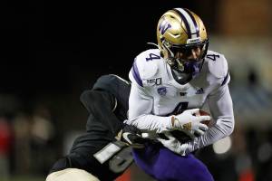 Colorado defensive back Tarik Luckett, back, pulls down Washington wide receiver Terrell Bynum after he caught a pass during the second half of an NCAA college football game Saturday, Nov. 23, 2019, in Boulder, Colo. Colorado won 20-14. (AP Photo/David Zalubowski)