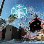 Protesters broke windows at a Starbucks store July 19 in Seattles Capitol Hill neighborhood. (AP Photo/Ted S. Warren)