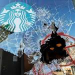 Broken windows are shown at a Starbucks store, Sunday, July 19, 2020 in Seattle's Capitol Hill neighborhood. Protesters broke windows at the store earlier in the afternoon. (AP Photo/Ted S. Warren)
