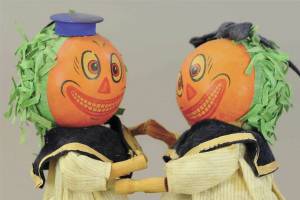 The pumpkin-head dancers are wearing their original blue felt and cotton sailor outfits. They are 8 1/2 inches tall and in excellent working condition, so a collector paid $1,920. (Cowles Syndicate Inc.)