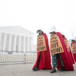 Activists opposed to the confirmation of President Trumps Supreme Court nominee, Judge Amy Coney Barrett, dressed as characters from The Handmaids Tale, protest at the Supreme Court on a foggy Thursday, Oct. 22, in Washington. (Jose Luis Magana / Associated Press)