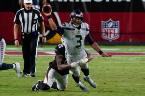 Seattle Seahawks quarterback Russell Wilson (3) gets the throw off as Arizona Cardinals linebacker Kylie Fitts makes the hit during the second half of Seattles 37-34 overtime loss Sunday at State Farm Stadium. (AP Photo/Rick Scuteri)