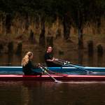 Aimelie Hovde-Girard (right) chats with Payton Wold as they row along the Snohomish River with the Everett Rowing Association on Oct. 19 in Everett. The rowers usually compete in teams of eight, but due to COVID-19, most row single sculls. (Andy Bronson / The Herald)