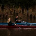 Aimelie Hovde-Girard (right) chats with Payton Wold as they row along the Snohomish River with the Everett Rowing Association on Oct. 19 in Everett. The rowers usually compete in teams of eight, but due to COVID-19, most row single sculls. (Andy Bronson / The Herald)