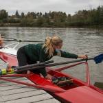 Everett Rowing Association rower Payton Wold flips an oarlock into place as she readies her single scull. (Andy Bronson / The Herald)