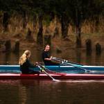 Aimelie Hovde-Girard, right, chats with Payton Wold as they row along the Snohomish River with the Everett Rowing Association on Monday, Oct. 19, 2020 in Everett, Washington. The rowers usually compete in teams of eight, but due to COVID-19, most row single sculls.  (Andy Bronson / The Herald)
