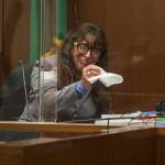 Jana Smith becomes emotional while looking at photographs during her testimony Wednesday in Everett. (Olivia Vanni / The Herald)