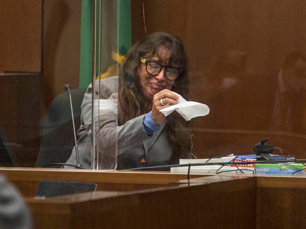 Jana Smith becomes emotional while looking at photographs during her testimony Wednesday in Everett. (Olivia Vanni / The Herald)