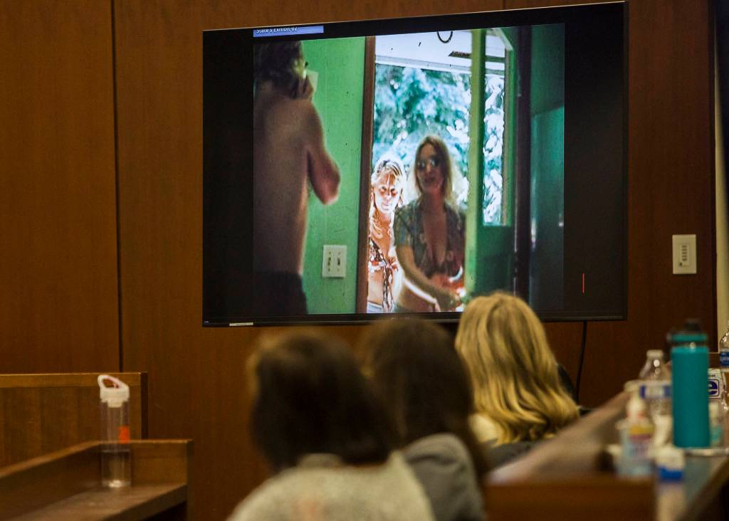 A photo of Jody Loomis and neighbor Linda Hook is shown during Hooks testimony Wednesday in Everett. (Olivia Vanni / The Herald)
