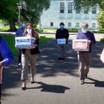 This photo from video provided by the Yes on Measure 110 Campaign shows volunteers delivering boxes containing signed petitions in favor of the measure to the Oregon Secretary of States office in Salem on June 26, 2020. (Yes on Measure 110 Campaign via AP)