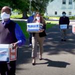 This photo from video provided by the Yes on Measure 110 Campaign shows volunteers delivering boxes containing signed petitions in favor of the measure to the Oregon Secretary of State's office in Salem on June 26, 2020. In what would be a first in the U.S., possession of small amounts of heroin, cocaine, LSD and other hard drugs could be decriminalized in Oregon under a ballot measure that voters are deciding on in Tuesday's election. Oregon's Measure 110 is one of the most watched referendums in the state because it would drastically change how the justice system treats people with amounts of the drugs for their personal use. Instead of going to trial and facing possible jail time, people caught with the drugs would have the option of paying $100 fines or attending new "addiction recovery centers." (Yes on Measure 110 Campaign via AP)