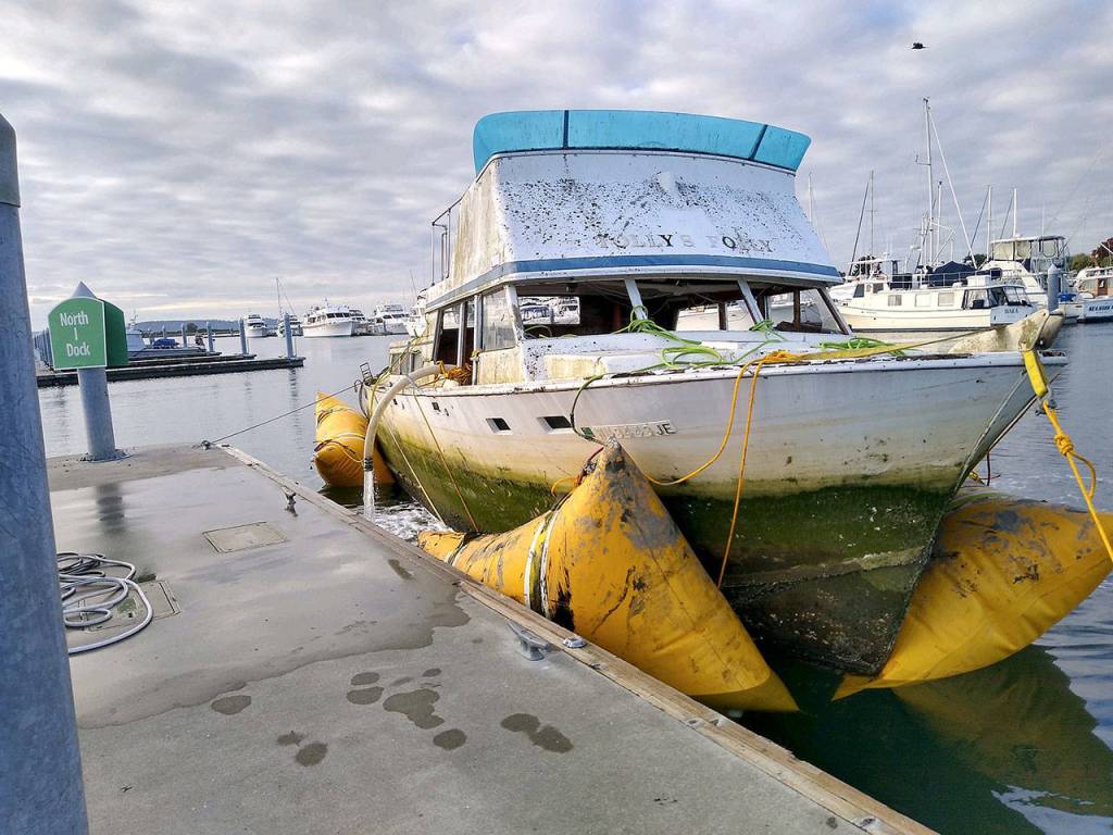 Tollys Folly was towed out of the Snohomish River on Oct. 21 by contractors after the county took custody of the derelict vessel earlier this month. (Snohomish County Surface Water Management)