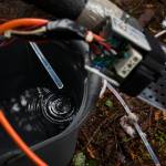 Distilled water drips into a bucket from an energy-saving device made by Scott Greeley using a low-fuel pump and gravity instead of a power-consuming compressor. (Andy Bronson / The Herald)