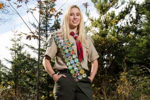 Molly McKinney, stands near her Eagle Scout project, one of many informational posts along the Allen Creek Interpretive Trail, on Monday, Nov. 2, 2020 in Marysville, Washington. The Marysville-Getchell senior is the first female to earn the the Eagle Scout badge in Snohomish County. (Andy Bronson / The Herald)