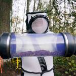 Sven Spichiger, Washington State Department of Agriculture managing entomologist, displays a canister of Asian giant hornets vacuumed from a nest in a tree behind him Oct. 24 in Blaine. (AP Photo/Elaine Thompson, file)