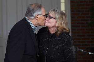 Washington Gov. Jay Inslee receives a congratulatory kiss from his wife Trudi before addressing the media after winning his third term as governor, Tuesday, Nov. 3, 2020 in Olympia, Wash. (Steve Bloom/The Olympian via AP)