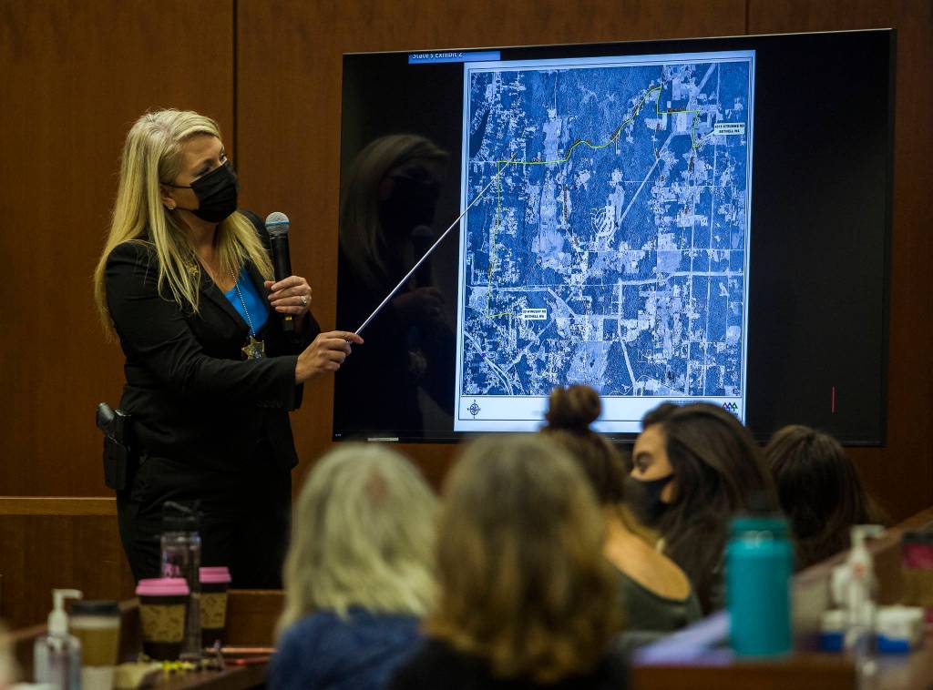 Snohomish County sheriffs detective Kendra Conley points to a map that shows where Jody Loomis lived in 1972 and where she kept her horse. (Olivia Vanni / The Herald)