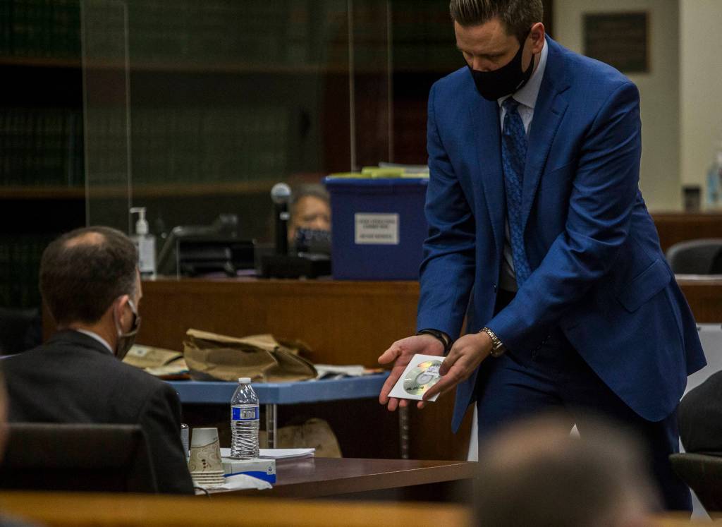 Snohomish County deputy prosecutor Bob Langbehn shows the defense a CD containing audio of a jail phone call made by Terrance Miller. (Olivia Vanni / The Herald)