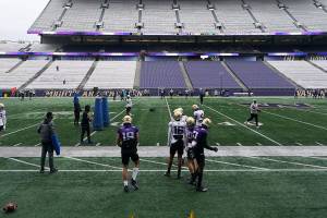 Washington players and coaches take part in NCAA college football practice, Friday, Oct. 16, 2020, at Husky Stadium in Seattle. (AP Photo/Ted S. Warren)