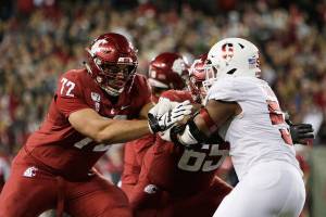 Washington State offensive lineman Abraham Lucas, left, and offensive lineman Josh Watson, center, block Stanford defensive end Jovan Swann during the second half of an NCAA college football game in Pullman, Wash., Saturday, Nov. 16, 2019. (AP Photo/Young Kwak)