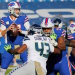 Buffalo Bills quarterback Josh Allen, left, looks to pass as teammate offensive tackle Daryl Williams (75) blocks Seattle Seahawks Carlos Dunlap (43) during the first half of an NFL football game Sunday, Nov. 8, 2020, in Orchard Park, N.Y. (AP Photo/Jeffrey T. Barnes)