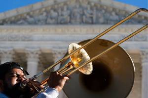 The "Too Much Talent," band performs in front of the U.S. Supreme Court as arguments are heard about the Affordable Care Act, Tuesday, Nov. 10, 2020, in Washington. (AP Photo/Alex Brandon)