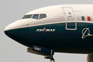 FILE- In this Sept. 30, 2020 file photo, a Boeing 737 Max jet, piloted by Federal Aviation Administration (FAA) chief Steve Dickson, prepares to land at Boeing Field following a test flight in Seattle. Boeing said Tuesday, Nov. 10 that it took no orders for new airliners in October and orders for 37 of its Max jets came off the books as the company continues to struggle with the grounding of the Max and a pandemic that has crippled demand for new planes. mBoeing delivered 13 airliners last month, down from 20 in October 2019. (AP Photo/Elaine Thompson, File)