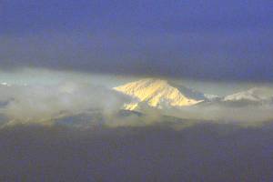 The Olympic mountains peek through clouds Wednesday morning. (Sue Misao / The Herald)