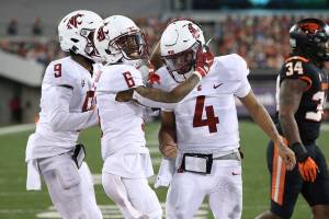 Washington State wide receivers Jamire Calvin (6) and Renard Bell (9) celebrate after their quarterback Jayden de Laura (4) scored a touchdown during the second half of an NCAA college football game against Oregon State in Corvallis, Ore., Saturday, Nov. 7, 2020. Washington State won 38-28. (AP Photo/Amanda Loman)