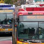 Metro buses post signs advising that masks are required Thursday, Nov. 12, 2020, in Seattle. Washington state and county health officials have warned of a spike in coronavirus cases across the state, and pleaded with the public to take the pandemic more seriously heading into the winter holidays. (AP Photo/Elaine Thompson)