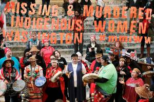 Native American tribal members sing and drum in the rotunda of the Capitol in Olympia, Wash., Tuesday, Jan. 23, 2018. The gathering was part of Native American Indian Lobby Day and supported issues such as the Puyallup Tribe's protest against the construction of a liquified natural gas plant being built in Tacoma, Wash. by Puget Sound Energy, as well as the awareness of missing and murdered indigenous women in Washington state. (AP Photo/Ted S. Warren)
