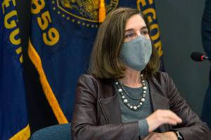 Oregon Gov. Kate Brown attends a news conference Tuesday, Nov. 10, 2020, in Portland, Ore. Brown and Oregon health officials warned Tuesday of the capacity challenges facing hospitals as COVID-19 case counts continue to spike in the state. (Cathy Cheney/Pool Photo via AP)