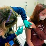 Clinical research coordinator Tammy Lewis-McCauley administers an injection to Katelyn Evans, a trial participant, as part Cincinnati Childrens Hospital Medical Centers clinical trial of Pfizers covid-19 vaccine on Oct. 14. (Cincinnati Childrens Hospital Medical Center via AP)