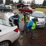 Volunteers load a car with food during a drive-through event for families in need called the “Colors of Fall” at the Darrington Food Bank on Monday, Nov. 23, 2020 in Darrington, Washington. Stops along the drive-thru provided hand sanitizer, masks, food boxes, assistance information for those that need help with early learning, utilities, mental health, etc.  (Andy Bronson / The Herald)