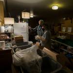 Hugh Kahn and Steve Brown (right) organize frozen items for a drive-through event for families in need called the Colors of Fall at the Darrington Food Bank on Monday. (Andy Bronson / The Herald)