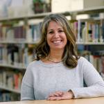 Middle-school counselor Shanon Baker poses for a photo in the schools library Wednesday in Sammamish. A masters degree and a full-time job werent enough to help Baker land an apartment she could afford in Seattles east-side suburbs. (AP Photo/Elaine Thompson)
