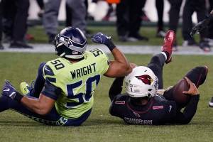 Arizona Cardinals quarterback Kyler Murray (1) is tackled by Seattle Seahawks outside linebacker K.J. Wright (50) during the first half of an NFL football game, Thursday, Nov. 19, 2020, in Seattle. (AP Photo/Elaine Thompson)