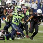 Seattle Seahawks running back Carlos Hyde (30) rushes against the Arizona Cardinals during the first half of Thursday nights game at Lumen Field. (AP Photo/Lindsey Wasson)