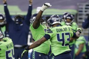 Seattle Seahawks defensive end Carlos Dunlap (43) celebrates with defensive end L.J. Collier, center-left, after Dunlap sacked Arizona Cardinals quarterback Kyler Murray late in the second half of an NFL football game, Thursday, Nov. 19, 2020, in Seattle. The Seahawks won 28-21. (AP Photo/Lindsey Wasson)