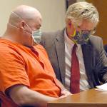 Ryan Warren Ward, left, looks over court papers with attorney Lane Wolfley during Ward's sentencing for three counts of aggravated first-degree murder and multiple counts of theft and firearms violations on Thursday in Clallam County Superior Court in Port Angeles. (Keith Thorpe/Peninsula Daily News)