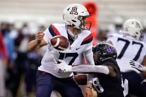Washington's Edefuan Ulofoshio, right, knocks the ball away from Arizona quarterback Grant Gunnell during the first half of an NCAA college football game Saturday, Nov. 21, 2020, in Seattle. (AP Photo/Elaine Thompson)