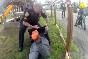 As seen in body-camera video, an Everett police sergeant places handcuffs on Joseph Michael Hill, 39, while kneeling on his back. Everett’s chief says it was reasonable use of force. Hill’s attorney disagrees. (Everett Police Department)
