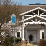 A woman walk up to closed doors at the Josephine Caring Community on Wednesday, March 11, 2018 in Stanwood, Wa.(Andy Bronson / The Herald)
