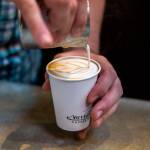 A barrista prepares a latte at Narrative Coffee in October 2018 in Everett. (Olivia Vanni / Herald file photo)